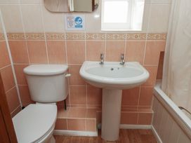 A bathroom with a toilet, sink, and bathtub at Stable Cottage in Clarbeston Road