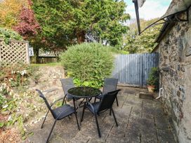 A garden with a table and chairs at Stable Cottage in Clarbeston Road