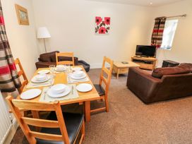 A dining area with a table set for meals at Swallows Cottage in Clarbeston Road