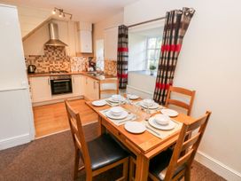 A dining room with a table set at Swallows Cottage in Clarbeston Road