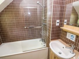A bathroom with a bathtub and sink at Swallows Cottage in Clarbeston Road
