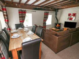 A dining room with a table set for dinner at Shippen Cottage Clarbeston Road