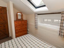 A bedroom with a dresser and mirror at Shippen Cottage Clarbeston Road