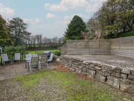 A garden with table and chairs and a grill at Shippen Cottage Clarbeston Road