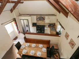 A kitchen with a dining table and chairs at Granary Cottage in Clarbeston Road