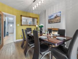A dining room with a table set for meals at Newlands in Yelverton