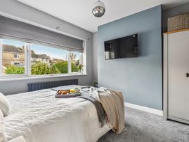 A bedroom with a bed and tv at Newlands Yelverton