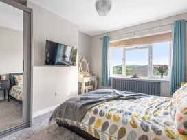 A bedroom with a bed and television at Newlands in Yelverton