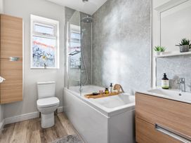 A bathroom with a bathtub and shower at Newlands in Yelverton