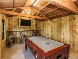 A snug with a pool table and bar stools at Rafters Cottage in Clarbeston Road