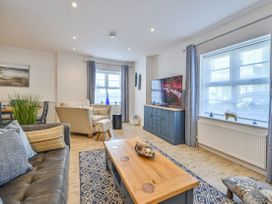 A living room with a sofa and TV at Number 2 Ellington Court Apartment in Torquay