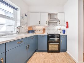 A kitchen with cabinets and appliances at Number 2 Ellington Court Apartment Torquay