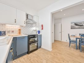 A kitchen with cabinets and utensils at Number 2 Ellington Court Apartment Torquay