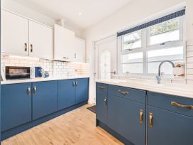 A kitchen with a sink and cabinets at Number 2 Ellington Court Apartment in Torquay