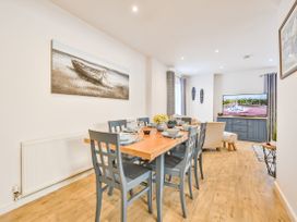 A dining room with a table setup and a television at Number 2 Ellington Court Apartment Torquay