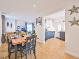 A dining room with a table and chairs at Number 2 Ellington Court Apartment in Torquay