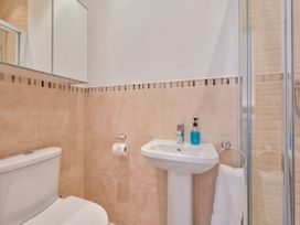 A bathroom with a toilet, sink, and shower at Number 2 Ellington Court Apartment Torquay
