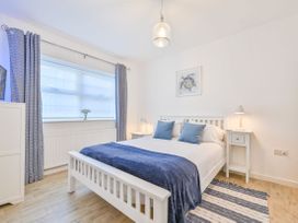 A bedroom with a bed and side tables at Number 2 Ellington Court Apartment in Torquay