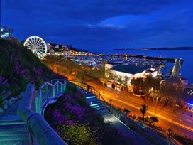 A view of the harbor with a ferris wheel and lights at Number 2 Ellington Court Apartment Torquay