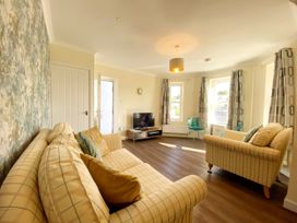 A living room with two sofas and a television at Ockedon House Apartment A Torquay