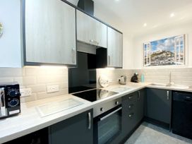 A kitchen with cabinets and appliances at Ockedon House Apartment A Torquay