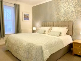 A bedroom with a bed and bedside table at Ockedon House Apartment A in Torquay