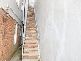 A staircase leading up between walls at Ockedon House Apartment A Torquay