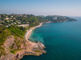 A coastal view with a beach and cliffs at Ockendon House Apartment A Torquay