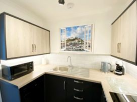 A kitchen with a sink and appliances at Ockendon House Apartment B Torquay