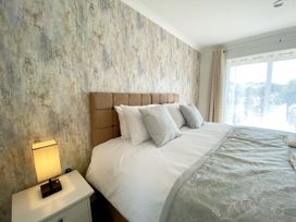 A bedroom with a bed and bedside lamp at Ockendon House Apartment B in Torquay