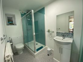 A bathroom with a shower, toilet, and sink at Ockendon House Apartment B Torquay