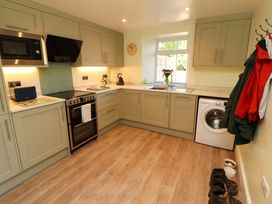 A kitchen with appliances and cabinets at East View in Kirkby Stephen