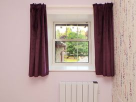 A bedroom with a window and radiator at East View in Kirkby Stephen