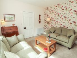 A living room with a sofa and coffee table at East View in Ravenstonedale near Kirkby Stephen