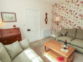 A living room with a coffee table and sofa at East View in Ravenstonedale near Kirkby Stephen