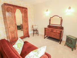A bedroom with furniture including a wardrobe and dressing table at East View in Ravenstonedale near Kirkby Stephen