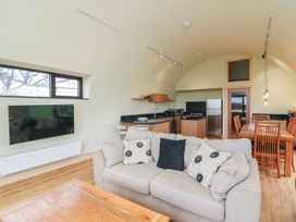 A living room with a sofa and dining area at The Rookery Rosslare Harbour, County Wexford