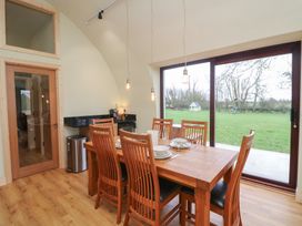 A dining room with a wooden table and chairs at The Rookery in Rosslare Harbour, County Wexford