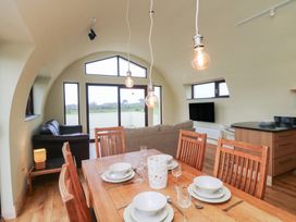 A dining room with a table and chairs at The Rookery in Rosslare Harbour, County Wexford