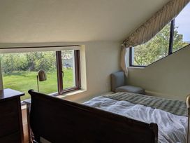 A bedroom with a window and bed at The Rookery in Rosslare Harbour, County Wexford