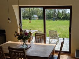 A dining room with a view of the garden and playground at The Rookery in Rosslare Harbour, County Wexford