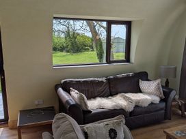 A living room with a sofa and window at The Rookery in Rosslare Harbour, County Wexford