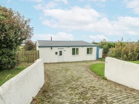 A cottage with a driveway in front at Harbour Lights in Holyhead