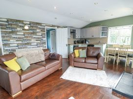 A living room with sofas and dining table at Harbour Lights in Holyhead