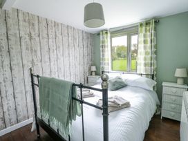 A bedroom with a bed and nightstands at Harbour Lights in Holyhead