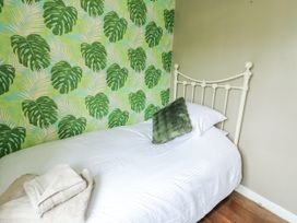 A bedroom with a bed and decorative wallpaper at Harbour Lights in Holyhead