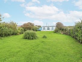 A garden with grass and bushes at Harbour Lights in Holyhead