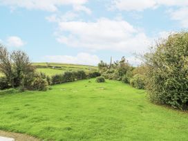A garden with grass and trees at Harbour Lights in Holyhead