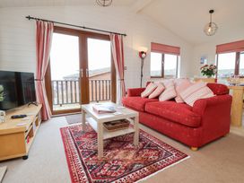 A living room with a sofa and coffee table at Ocean Terrace 28 Ilfracombe