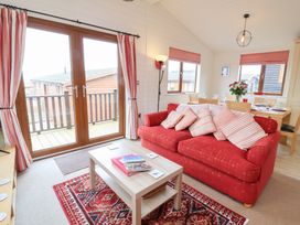 A living room with a sofa and coffee table at Ocean Terrace 28 in Ilfracombe